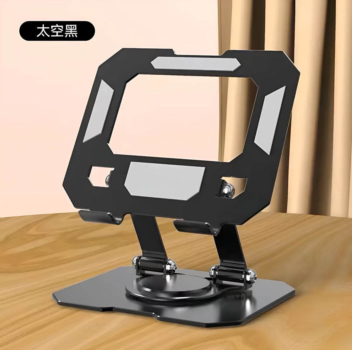 Black foldable laptop stand with metal grid design and height adjustment, placed on a desk with a laptop