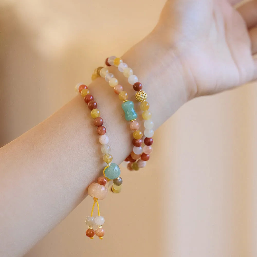 Women's handcrafted Jinsi Jade bracelet with three pumpkin circles and tassel decoration