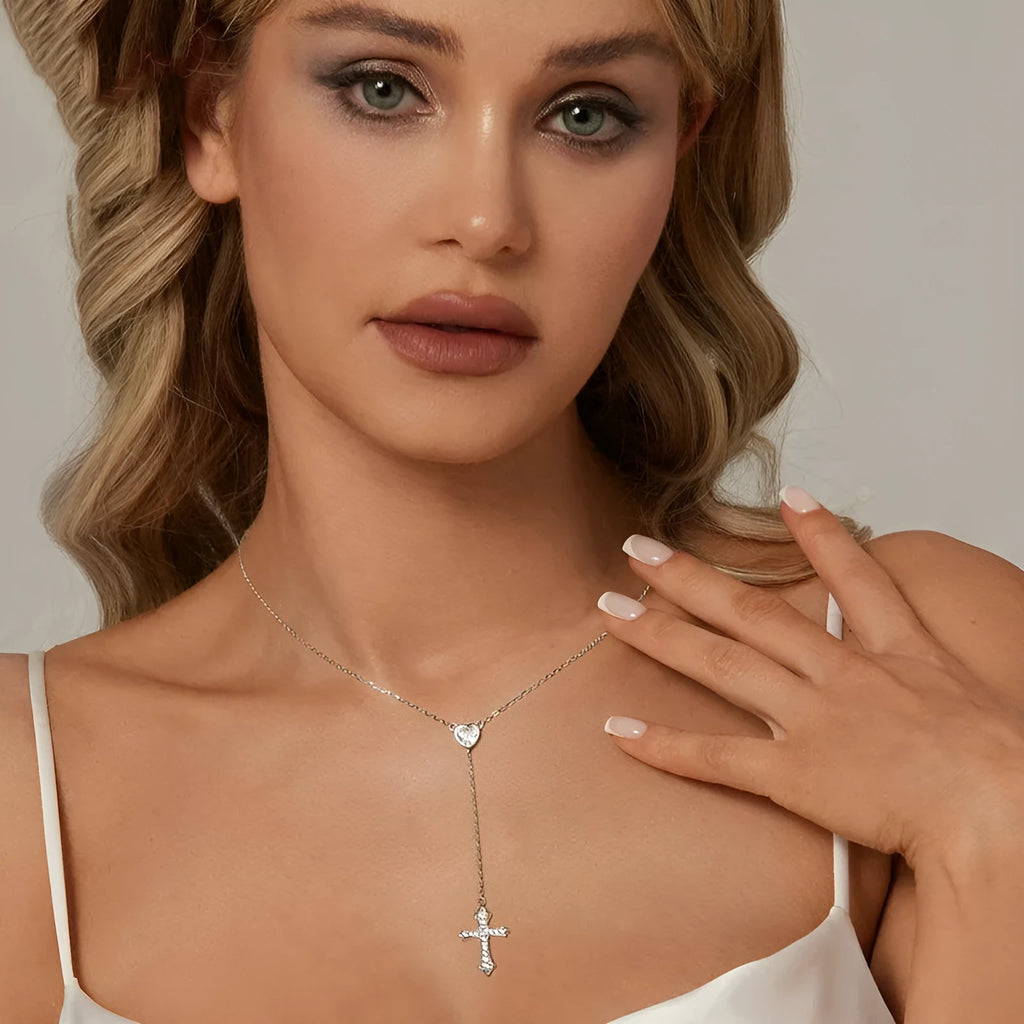 Close-up of a sterling silver V-neck love cross pendant on an O-ring chain.
