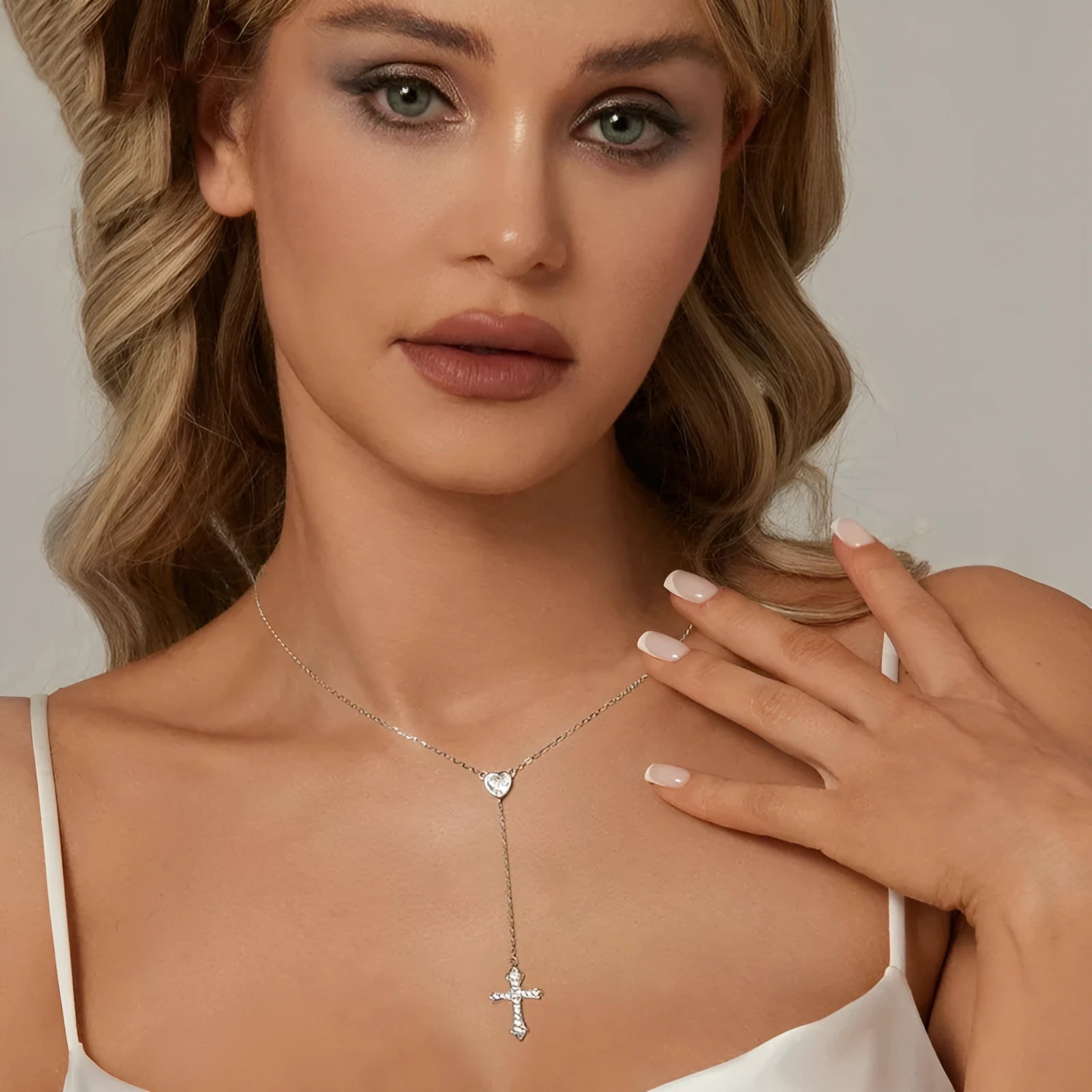 Close-up of a sterling silver V-neck love cross pendant on an O-ring chain.