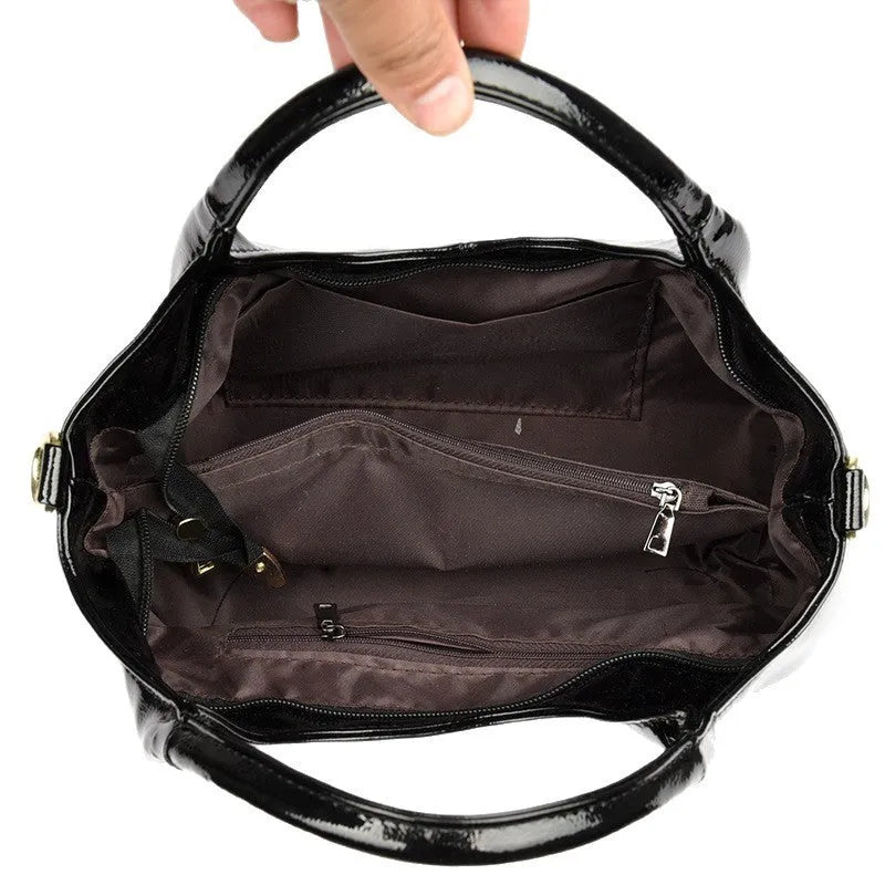 Genuine leather commuter bag with glossy finish, belt decoration, and leather grain in a horizontal square shape