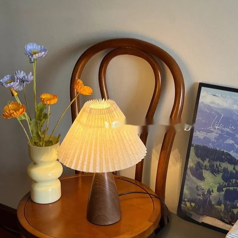 Nordic retro ceramic table lamp with a pleated tapered floral shade on a bedside table.