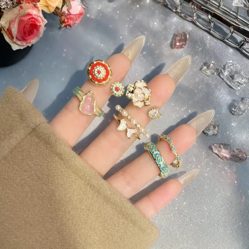 Close-up of an adjustable copper ring with a vintage oil-drip finish and a central gourd motif set with zircon stones.