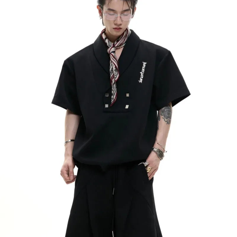 Men's dark grey V-neck cotton sports jacket with padded shoulders and metal trim, paired with matching shorts.
