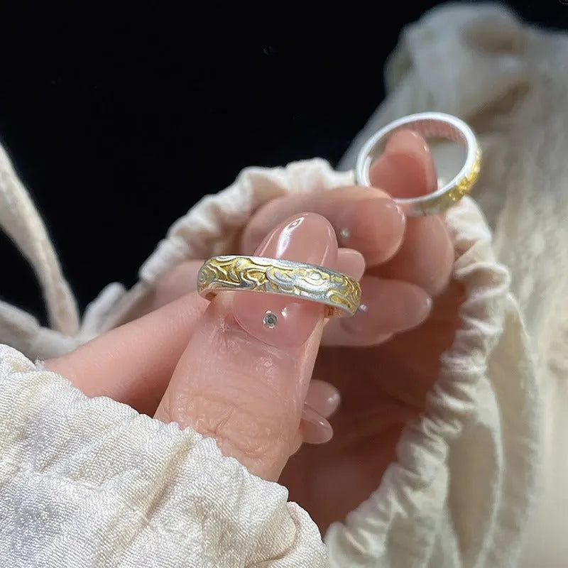 Geometric open-mouth silver and gold ring with a Xiangyun cloud pattern on a white copper band.