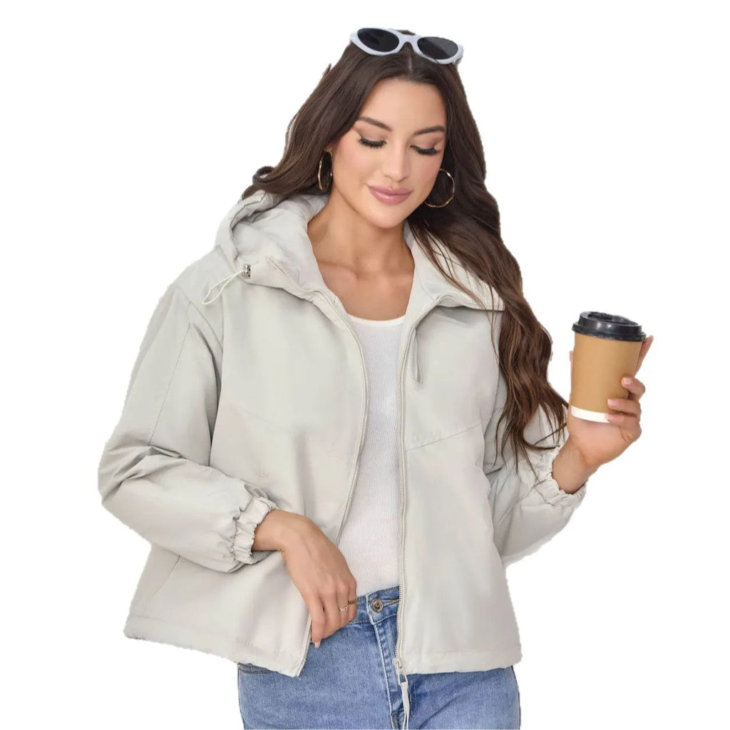 Grey loose-fit women's hooded shell jacket with long sleeves on a hanger.