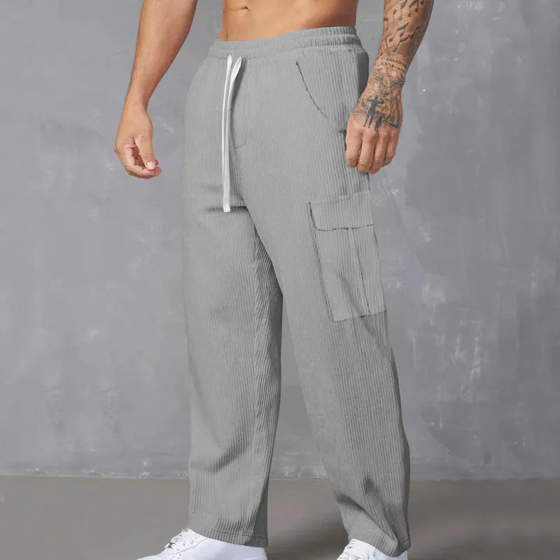Men's loose-fitting corduroy cargo trousers in army green with a straight leg and drawstring waist.