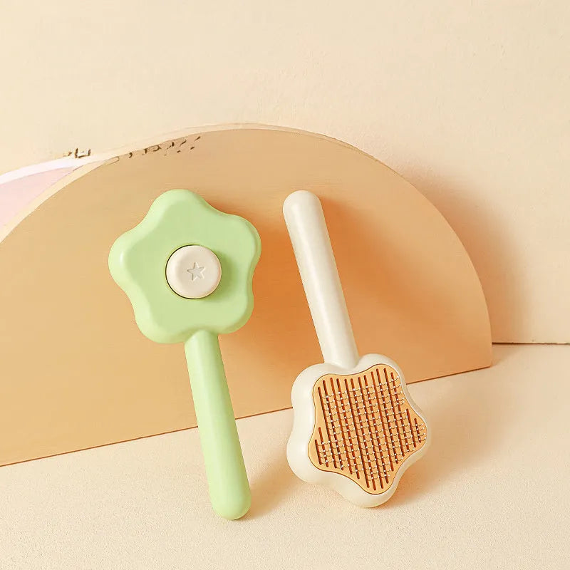 Green self-cleaning stainless steel magic wand cat comb on a white background.