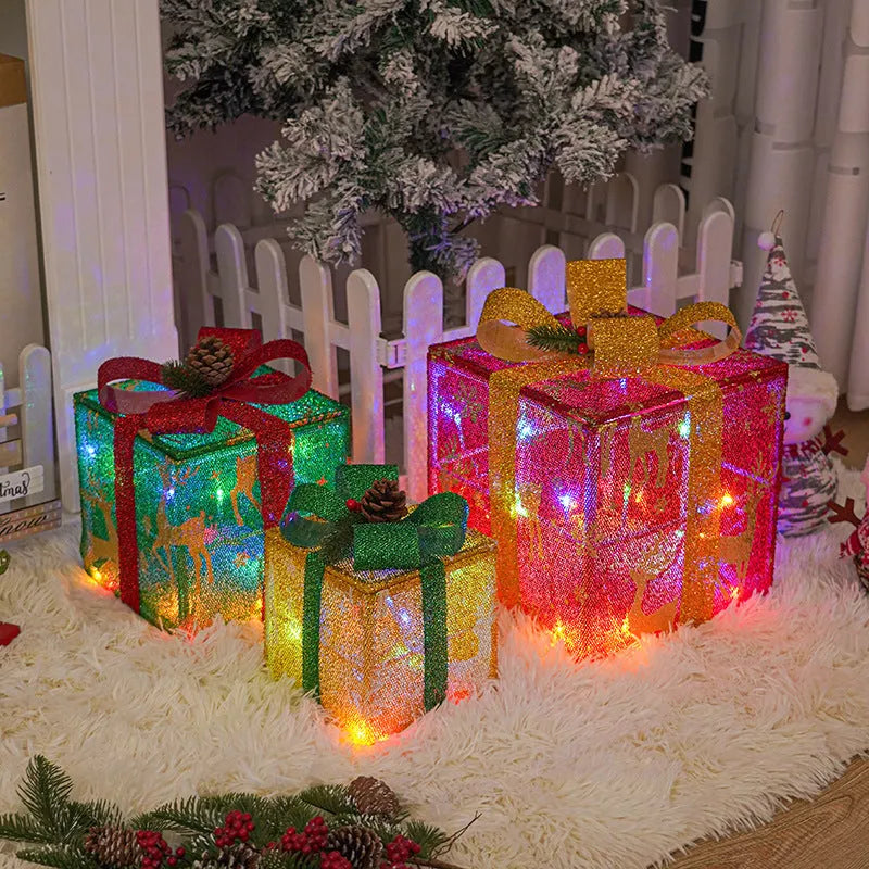Set of three pre-lit Christmas gift box decorations with fabric bows and LED lights