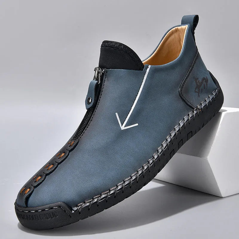 Men's black leather martin boots with a front zipper and round toe on a rubber sole.