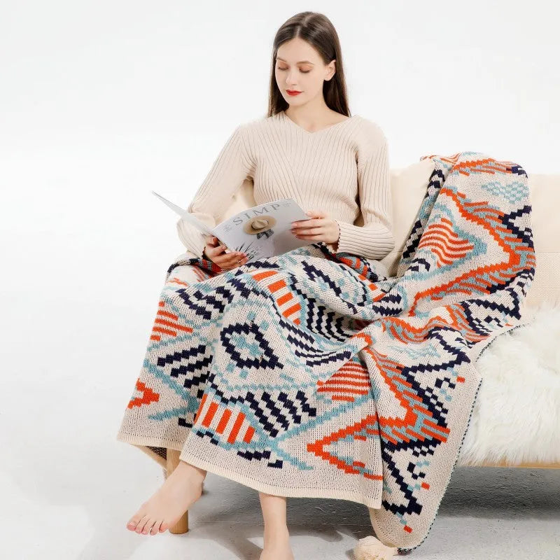 Bohemian style acrylic sofa cover blanket with tassel trim in a geometric pattern colour option.