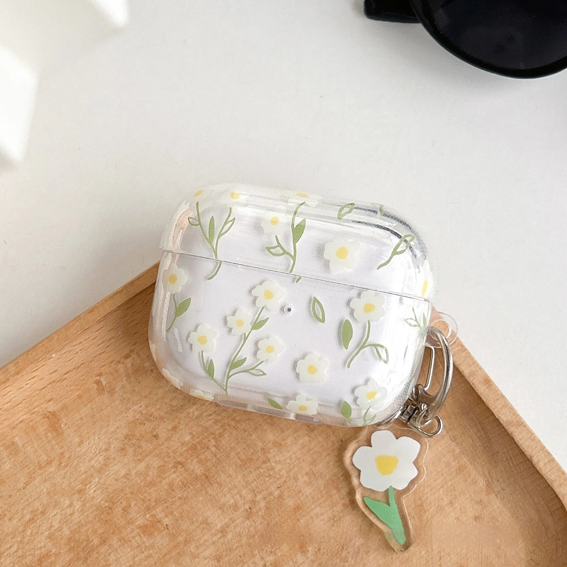 Transparent white floral TPU protective case for Apple AirPods showing decorative pattern