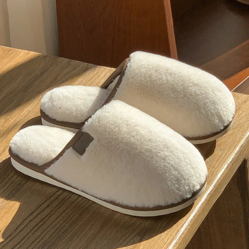 Winter plush slippers in blue with non-slip PVC sole and car stitching detail on the upper.
