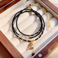 Women's three-ring layered bracelet with blue san stones in gold-toned settings, showing adjustable clasp