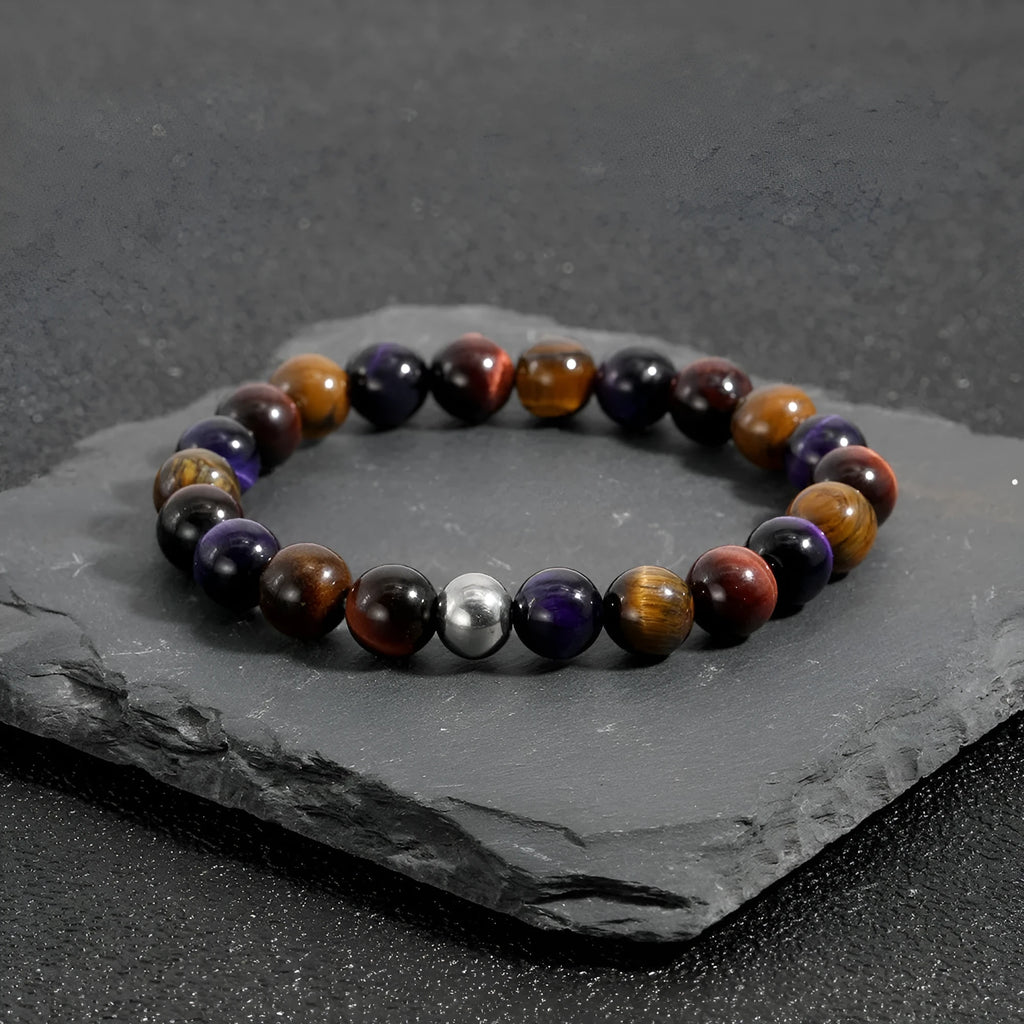 Handmade elastic bracelet with natural tiger-eye stones in geometric cut, yellow purple red colour variations
