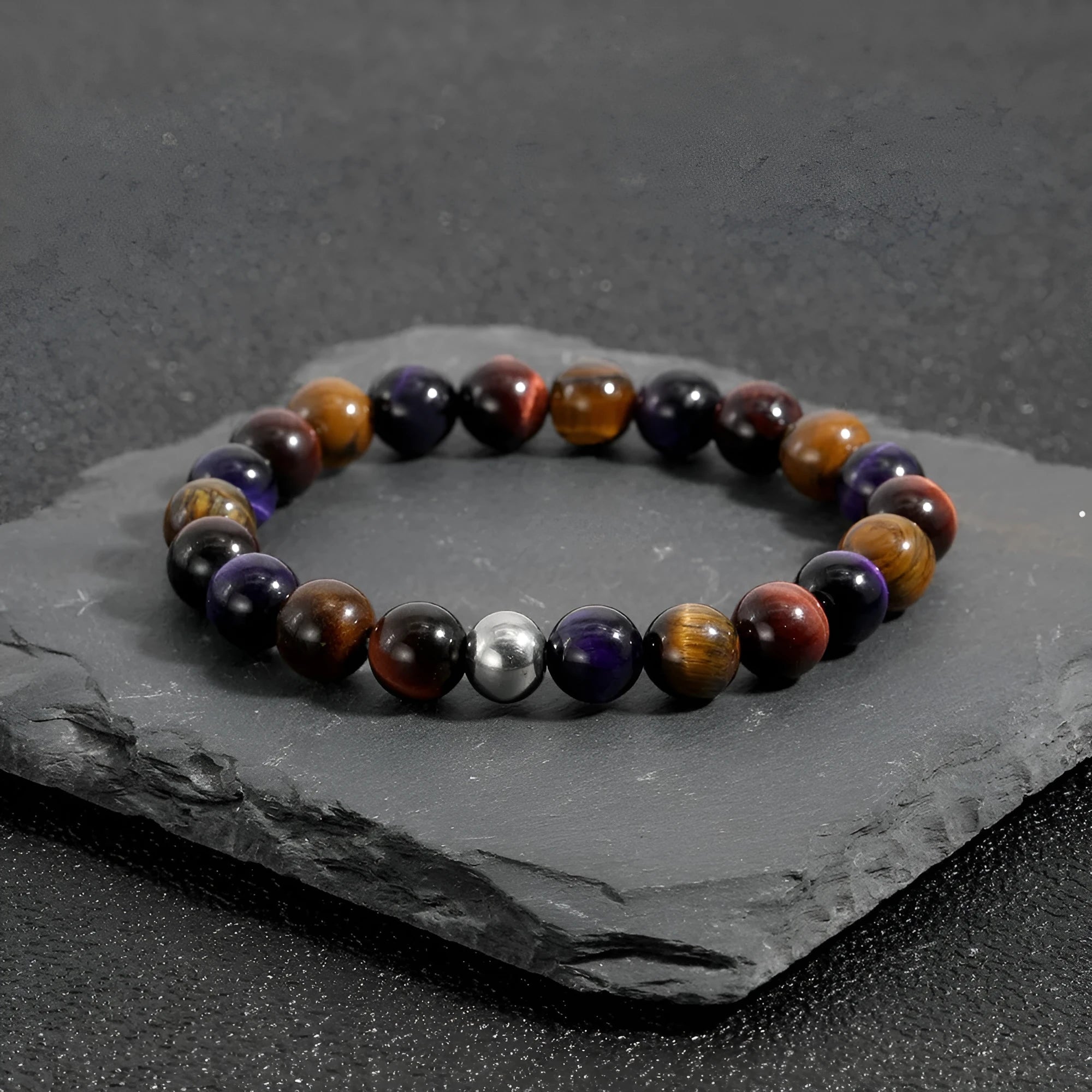 Handmade elastic bracelet with natural tiger-eye stones in geometric cut, yellow purple red colour variations