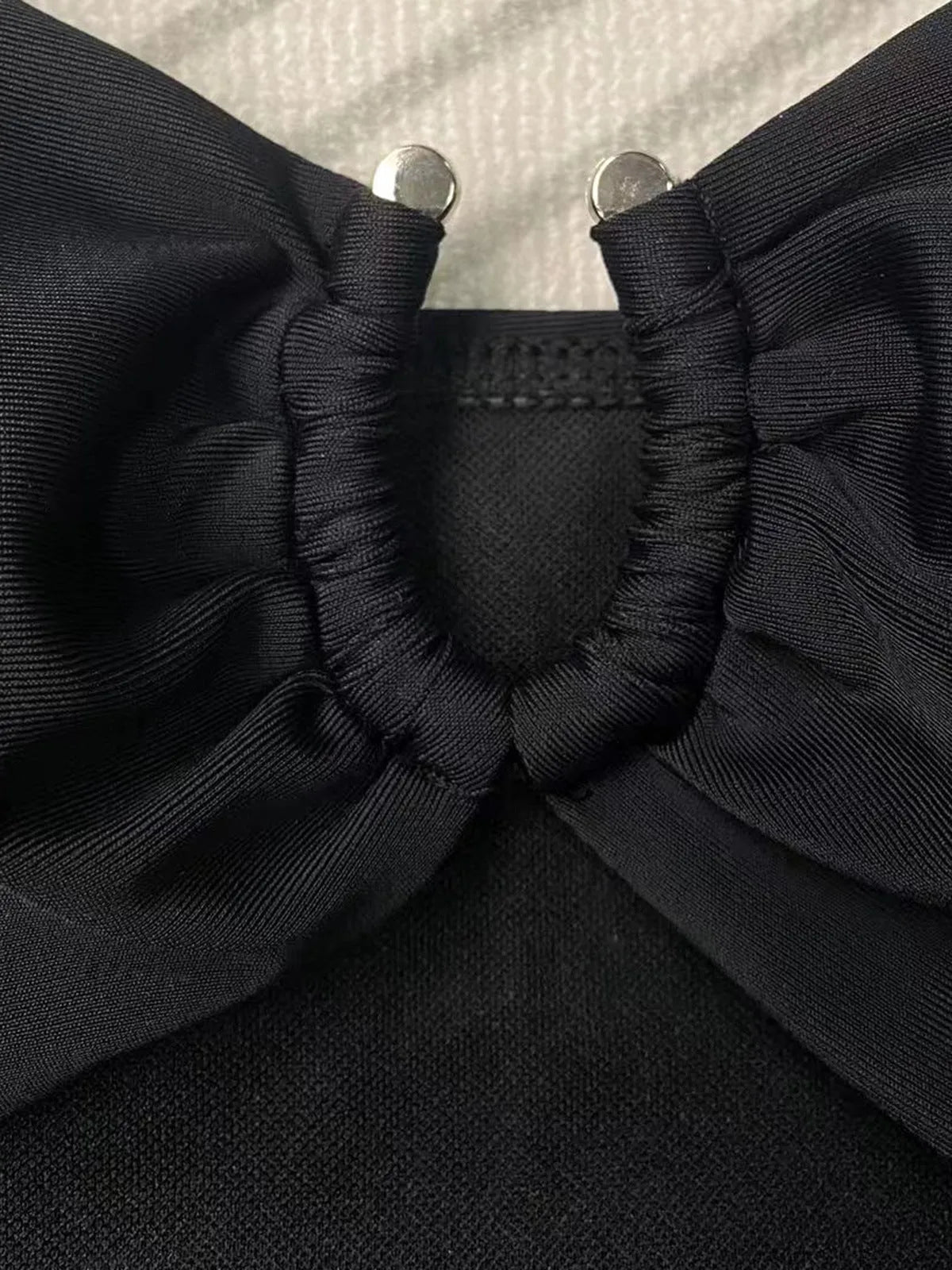 Solid black one-piece swimsuit for women on a mannequin.