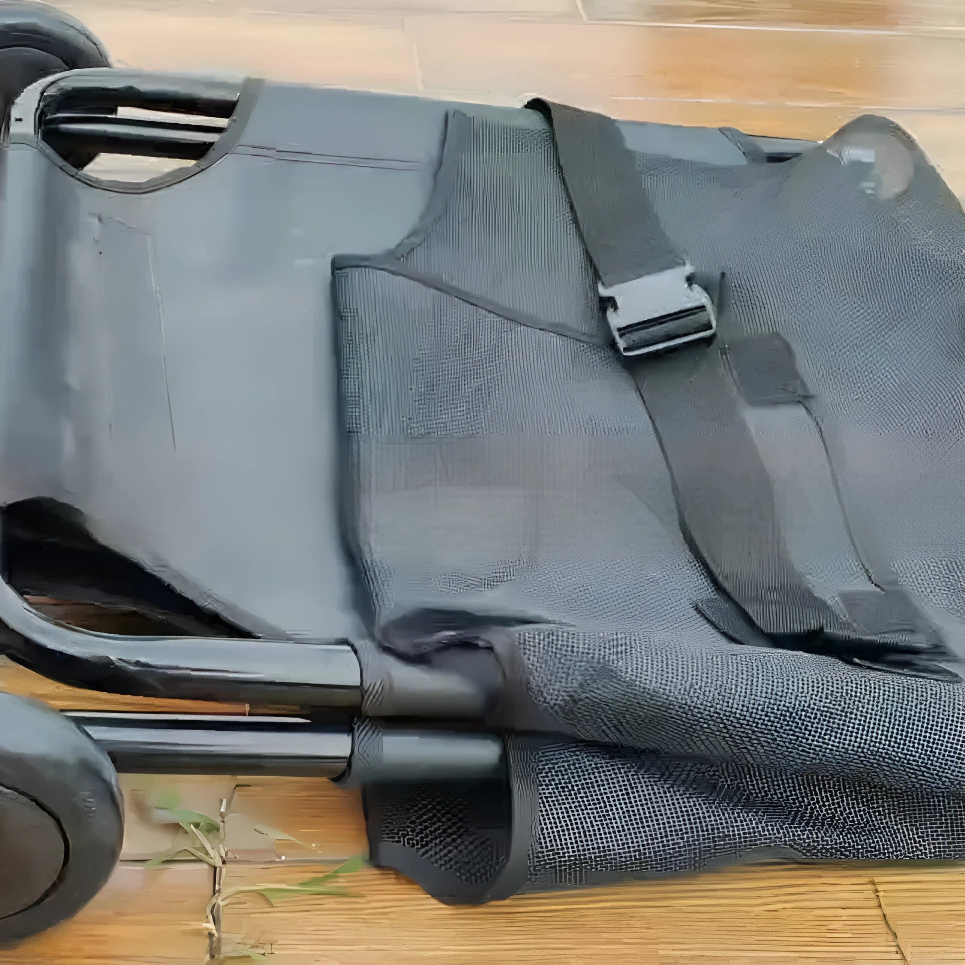 Black foldable aluminium alloy pet stretcher for large dogs in an emergency scenario.