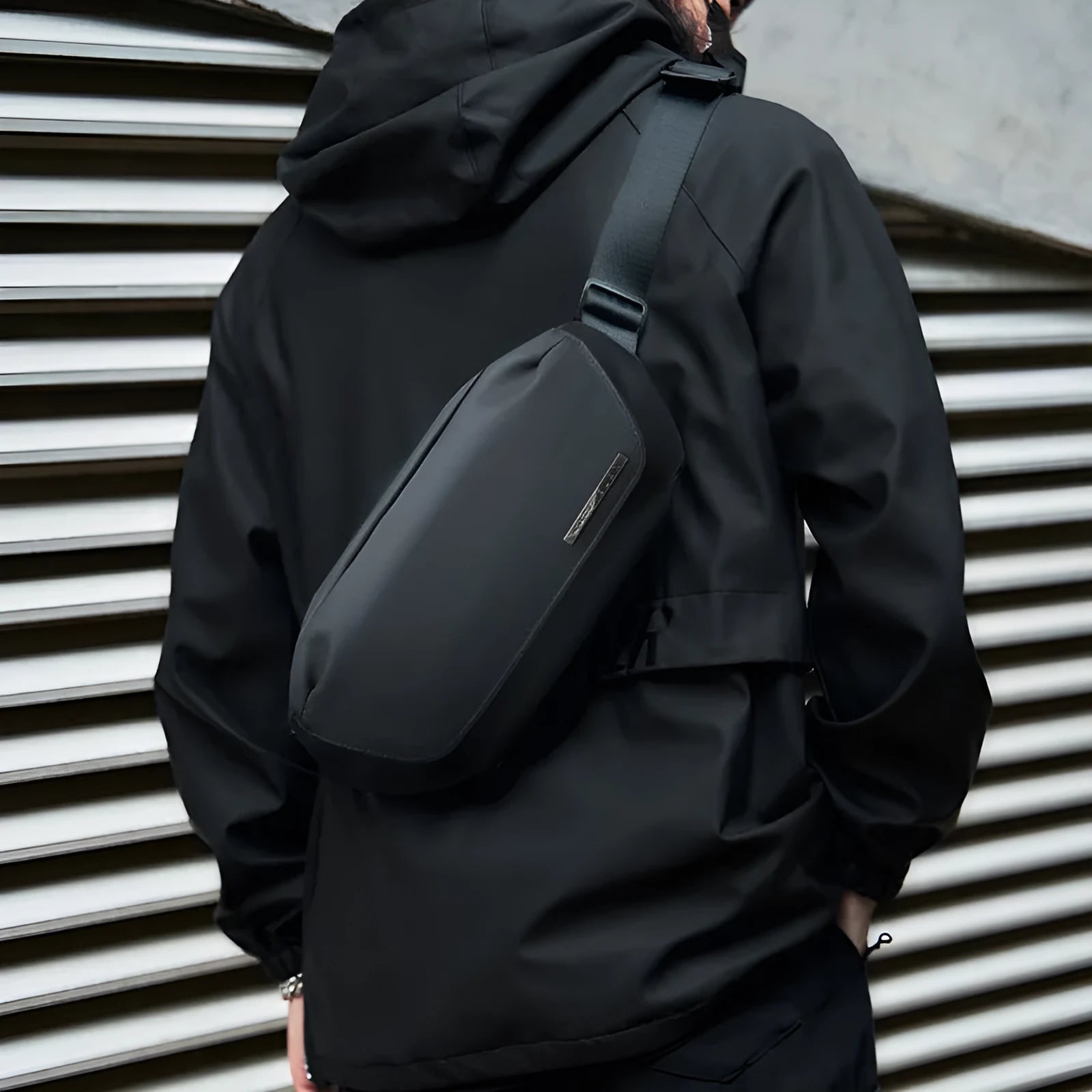 Black men's messenger bag in Oxford cloth with crossbody strap and street style details.