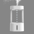 White anti-gravity water drop humidifier with coloured light on a desk next to USB cable