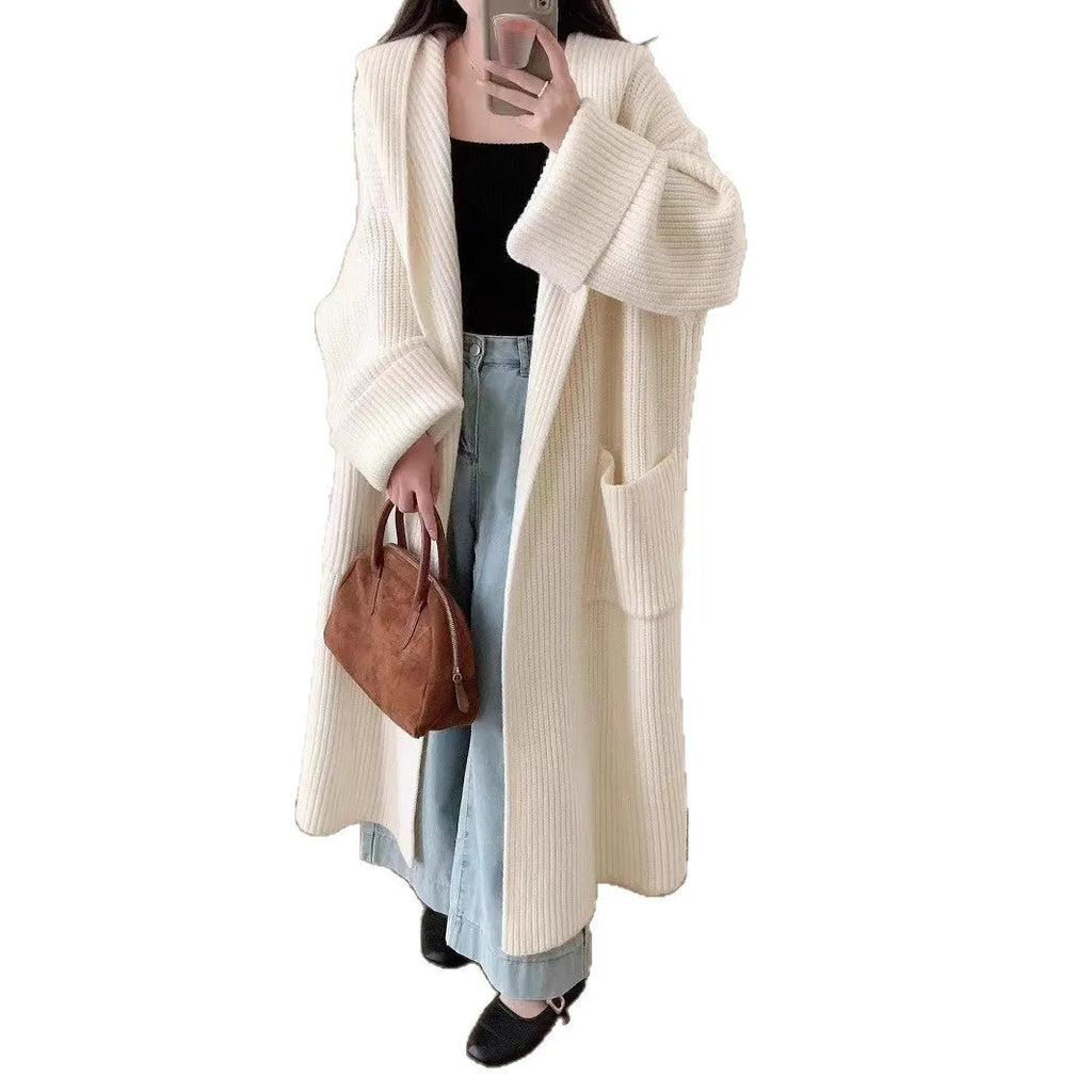 Loose grey hooded cardigan coat for women with raglan sleeves on a hanger