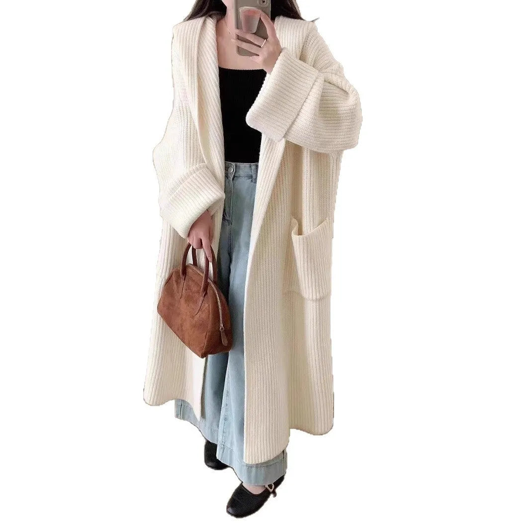 Loose grey hooded cardigan coat for women with raglan sleeves on a hanger