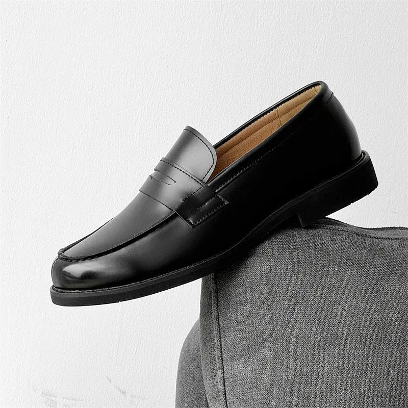 Men's black slip-on derby shoes with rubber sole showing height increasing feature