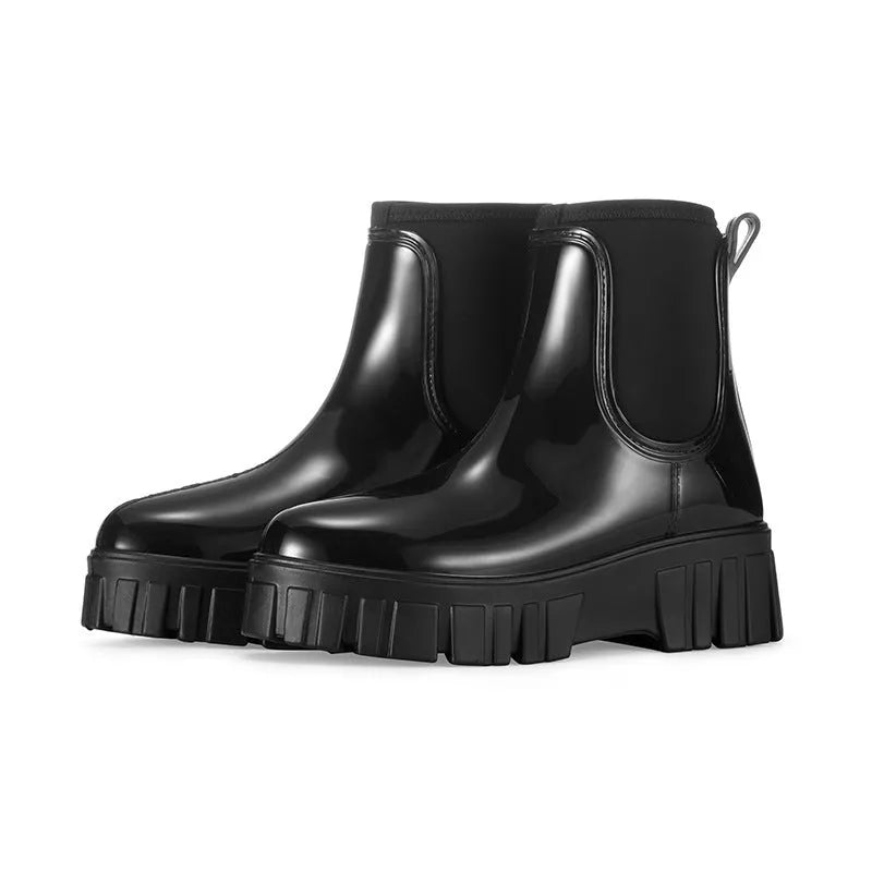 Women's creamy white PVC low tube rain boots with a flat heel on a white background.