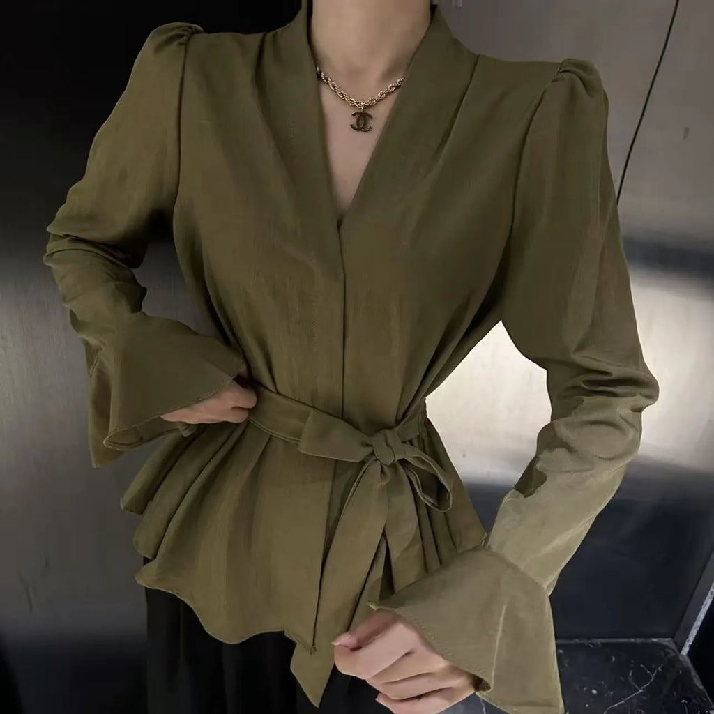 Women's black long sleeve shirt with an irregular collar and a tie closure at the neck.