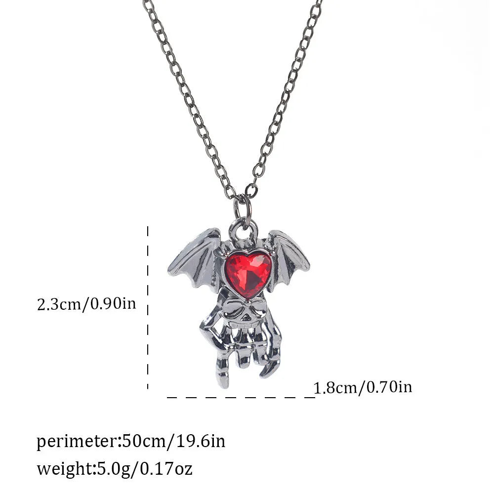 Halloween necklace with spider, bat, cross, and heart charm pendants on a metal chain.