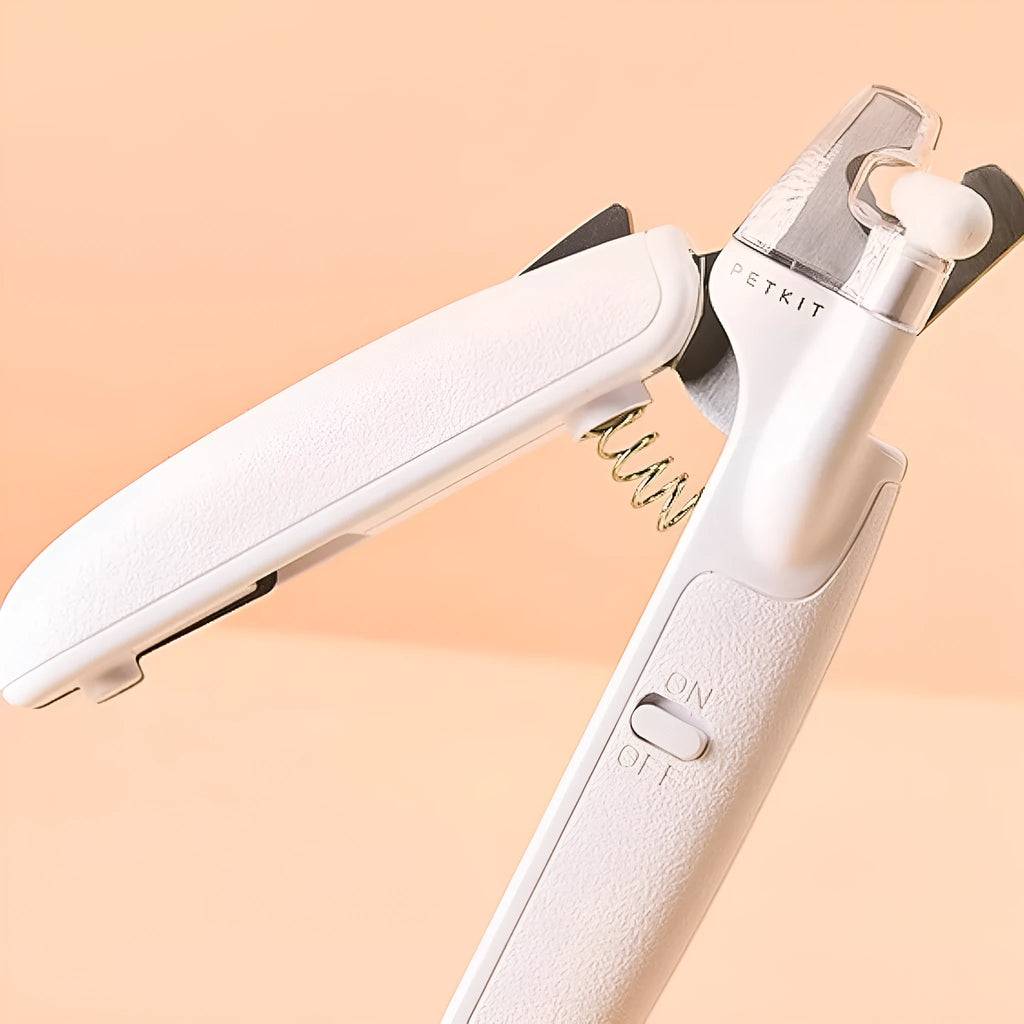 White pet nail clippers with LED light, transparent anti-splash guard, and triangular blade for cats and dogs