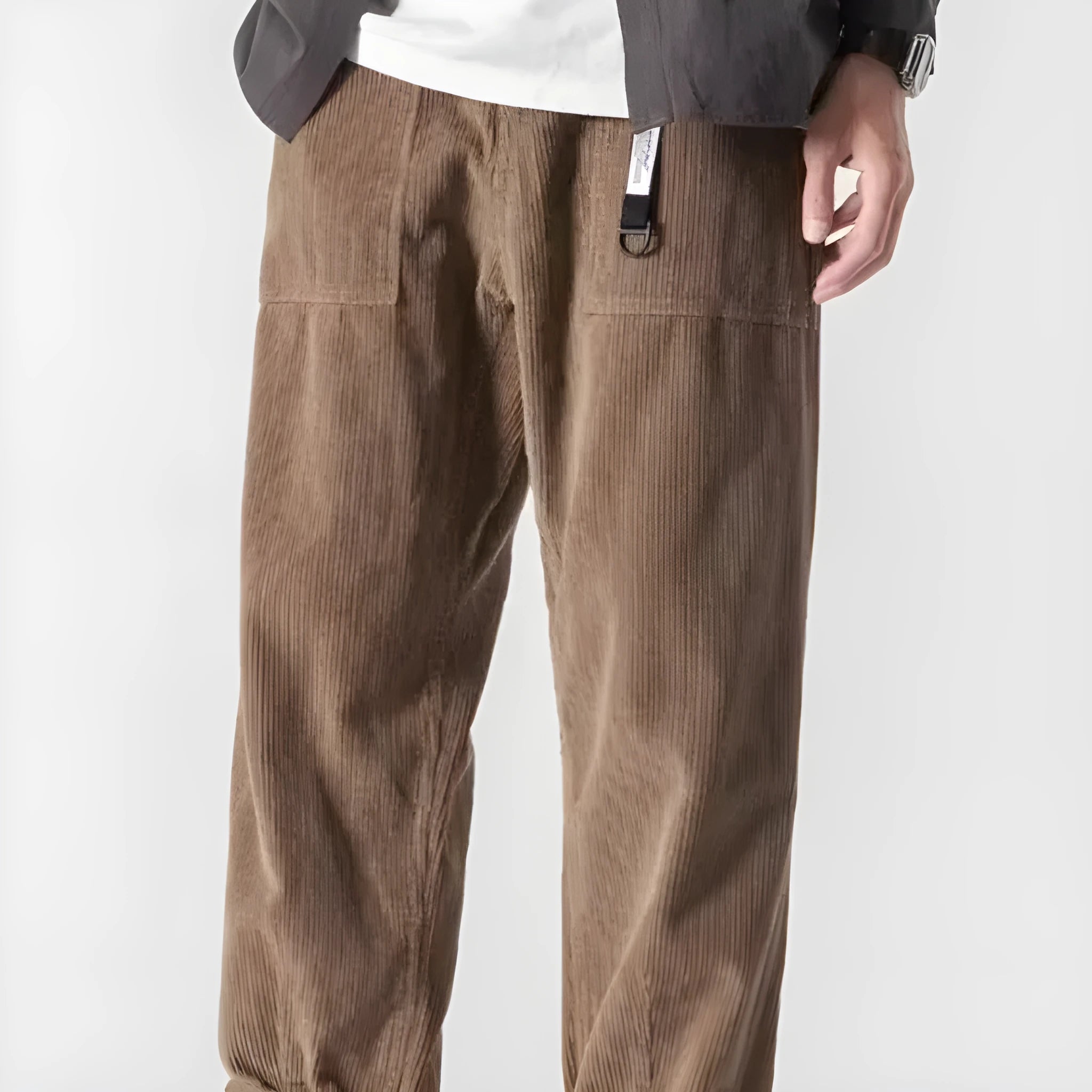 Man wearing loose straight tapered trousers in dark grey, showcasing the straight leg and relaxed fit.