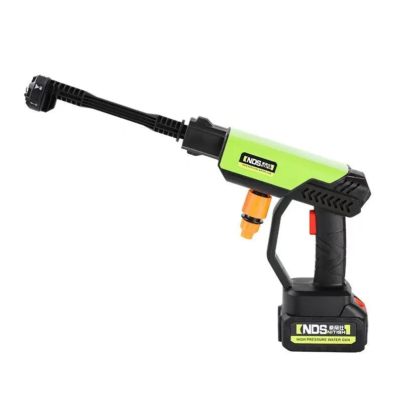 Green wireless high-pressure water gun with multiple nozzle attachments on a garden patio.