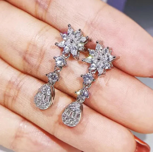Floral zircon bridal jewellery set including ring, necklace with curb chain, and earrings on brass