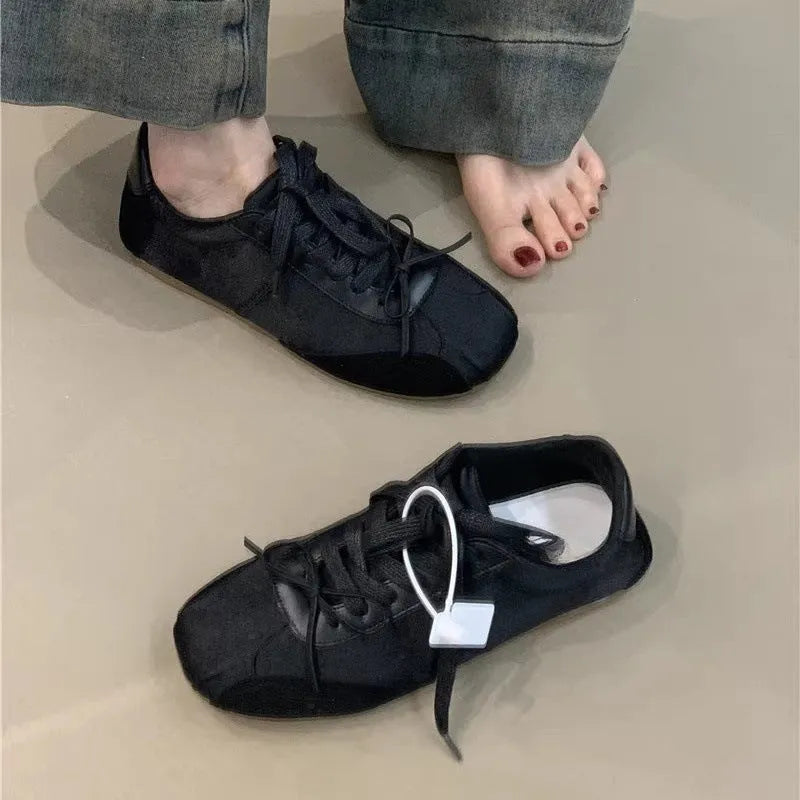 Women's low-top white sneaker with bow detail, microfiber upper, round toe, lace-up closure