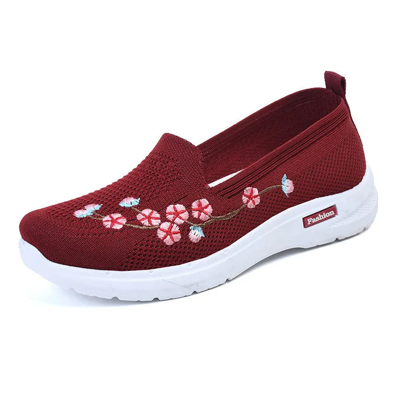 Women's wine red embroidered low heel pumps with round toe and anti-slip sole.
