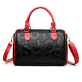 Red cylindrical crossbody bag with three straps and authentic leather tactile feel