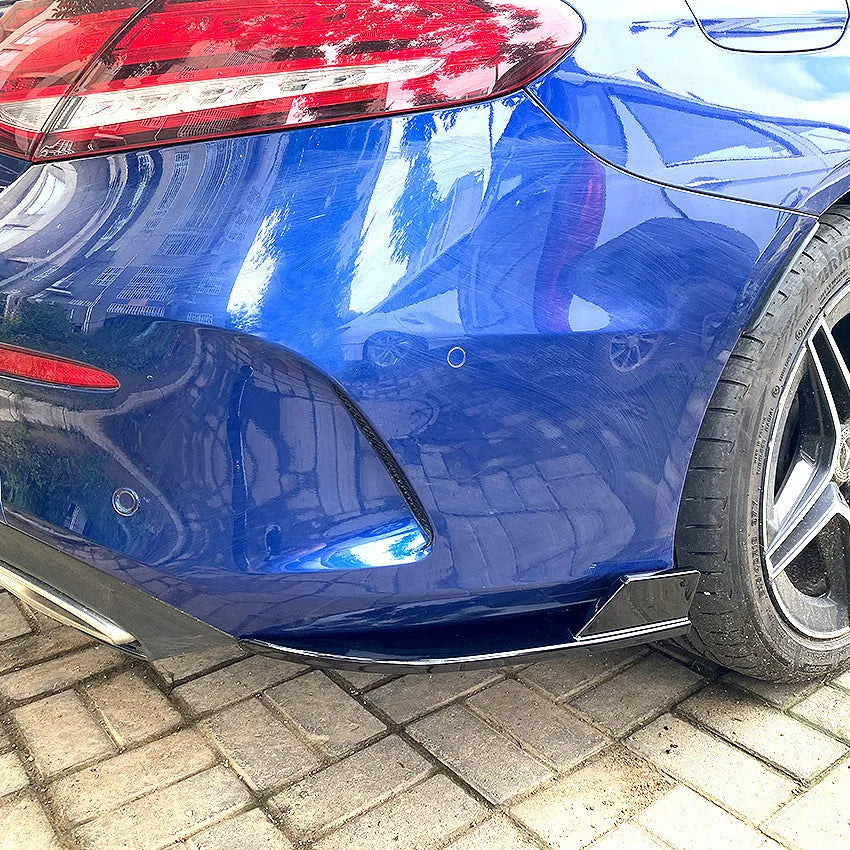 PP plastic car rear corner protectors in piano black and carbon fibre pattern finishes shown as a left and right set
