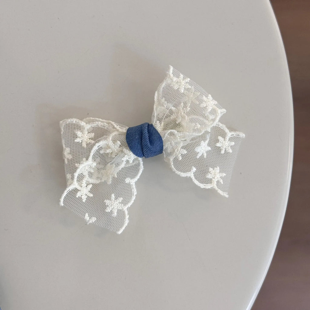 Beige lace hair rope barrette with blue bow decoration and metal clip
