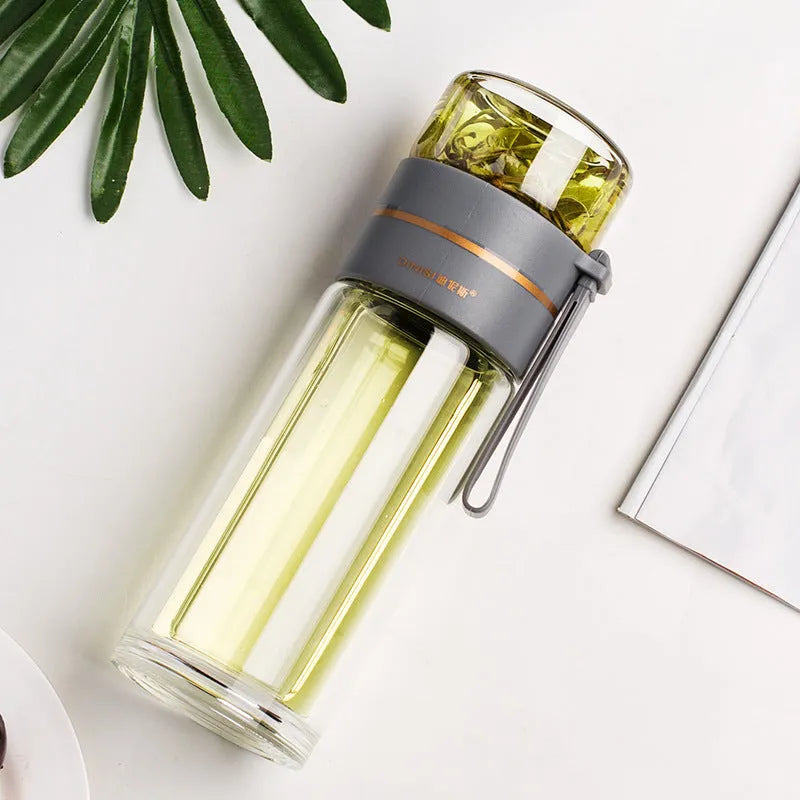 Glass water bottle with tea infuser filter showing double wall construction and portable rope