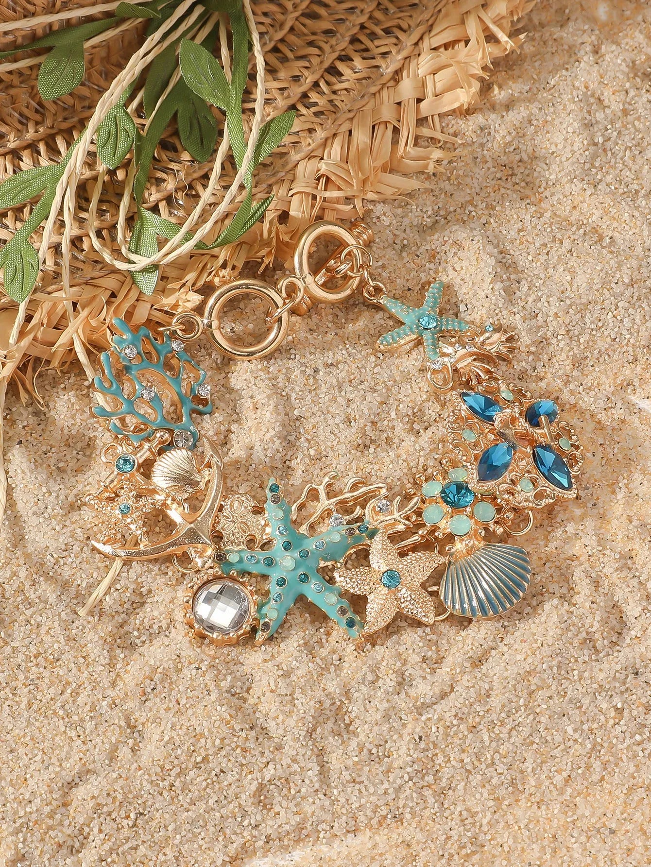 Women's alloy marine-themed bracelet with anchor, shell, and starfish charms in blue, red, or turquoise.