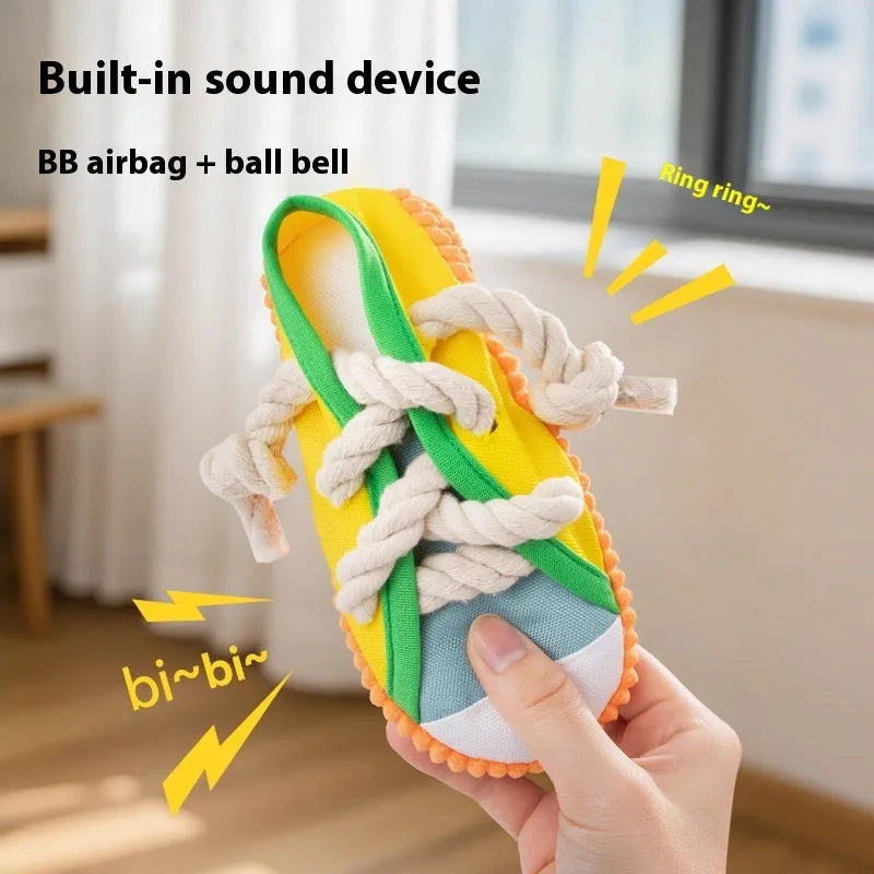 Yellow plastic dog toy shaped like a slipper with a squeaker for chewing.