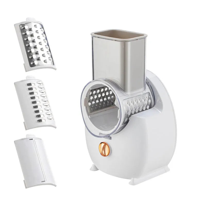 White electric vegetable slicer with suction base, feeding port, pressing rod, and multiple blades on a kitchen counter.