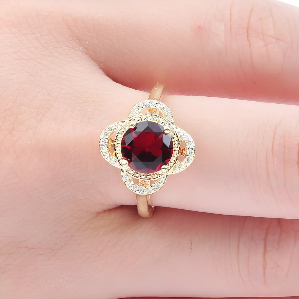 Copper fruit-shaped ring with inlaid zircon stones on a finger.