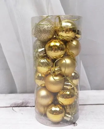 Assorted gold, red, silver, and blue 3cm plastic Christmas baubles spilling from a storage barrel.
