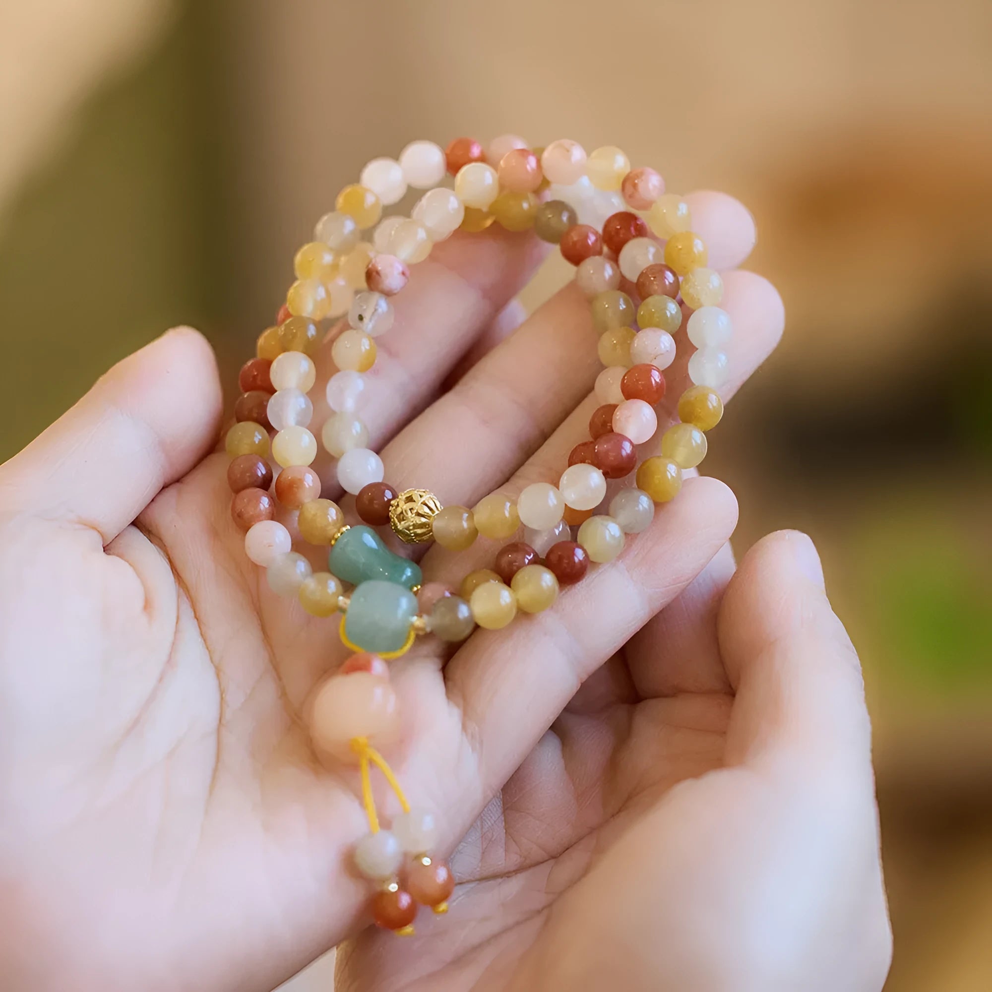 Women's handcrafted Jinsi Jade bracelet with three pumpkin circles and tassel decoration