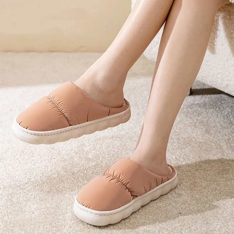 A pair of down cotton indoor slippers with a thick rubber sole and plush lining, shown in a choice of colours.