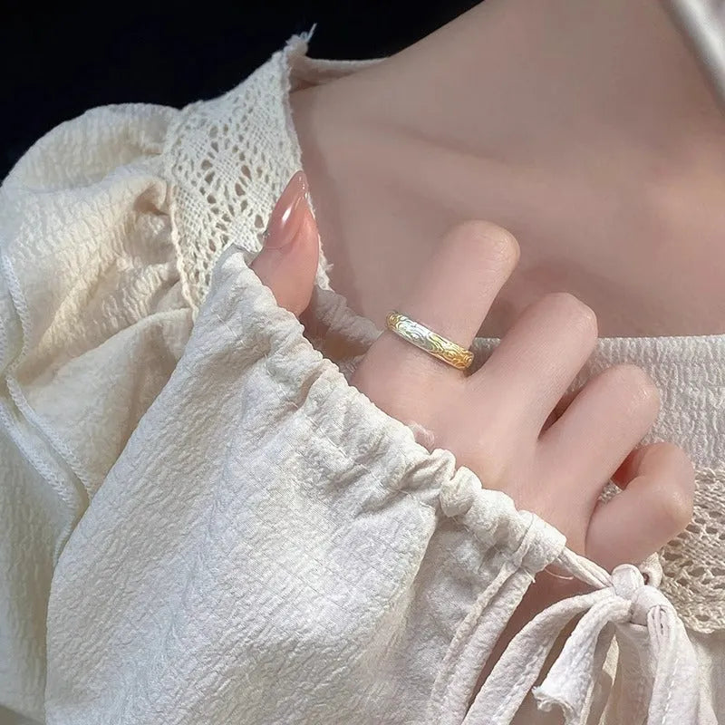 Geometric open-mouth silver and gold ring with a Xiangyun cloud pattern on a white copper band.