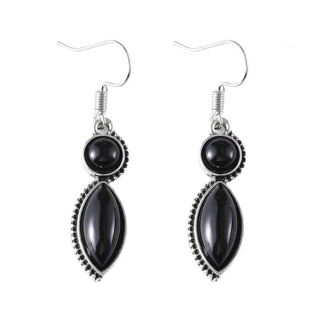 A pair of black and purple vintage geometric drop earrings with a round detail, shown against a plain background.