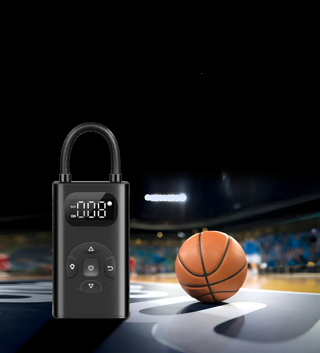 Black rectangular portable tyre inflator and power bank unit with a connected inflation hose on a table.